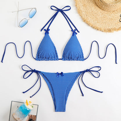 Blue gingham bikini set with sunglasses and a hat on a white background