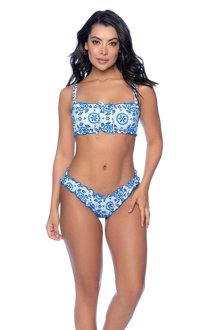 Woman wearing a blue and white patterned bikini on a white background