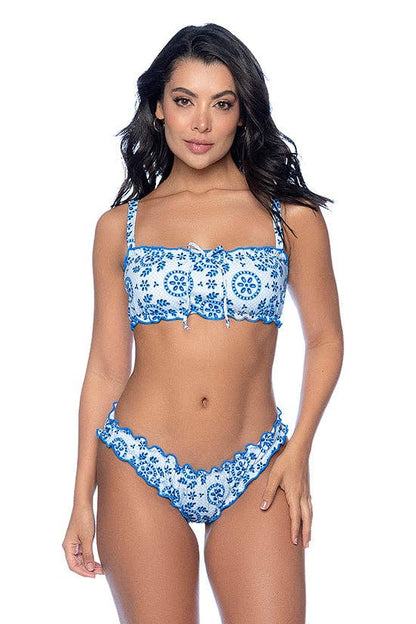 Woman wearing a blue and white patterned bikini on a white background